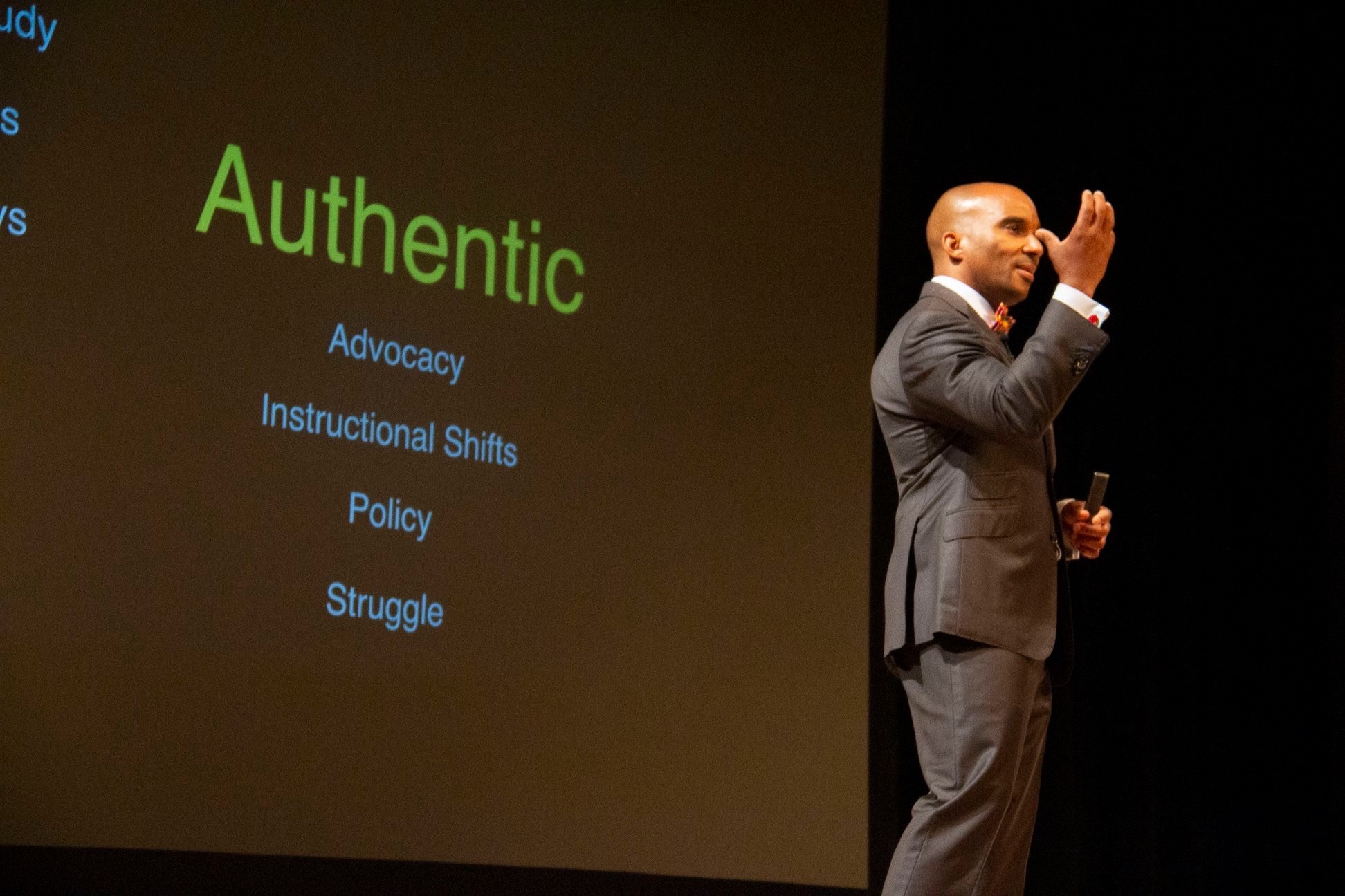 Luvelle Brown presenting with a handheld microphone